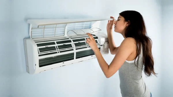 The women is trying to figure out why her air conditioner isn’t cooling