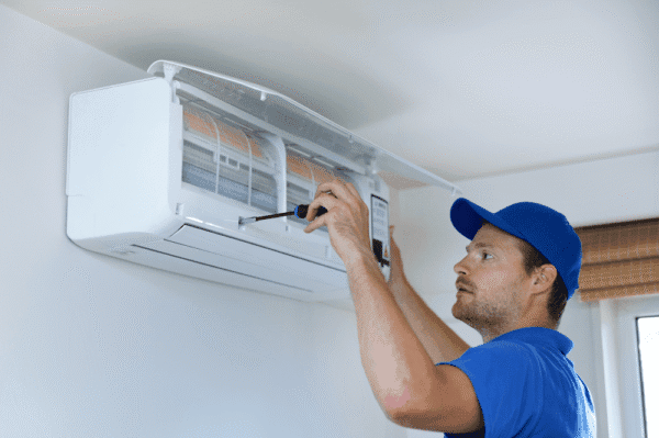 The man is repairing air conditioning.