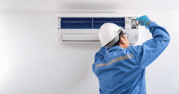 END-OF-YEAR AIR CONDITIONER CHECKUP - The technician is repairing air conditioner.