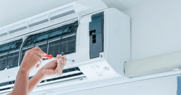 A hand of technician is doing a customized design air conditioner