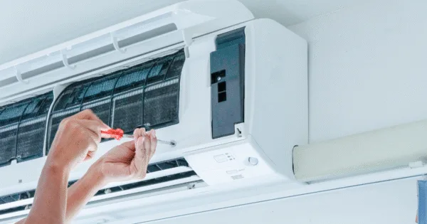 A hand of technician is doing a customized design air conditioner