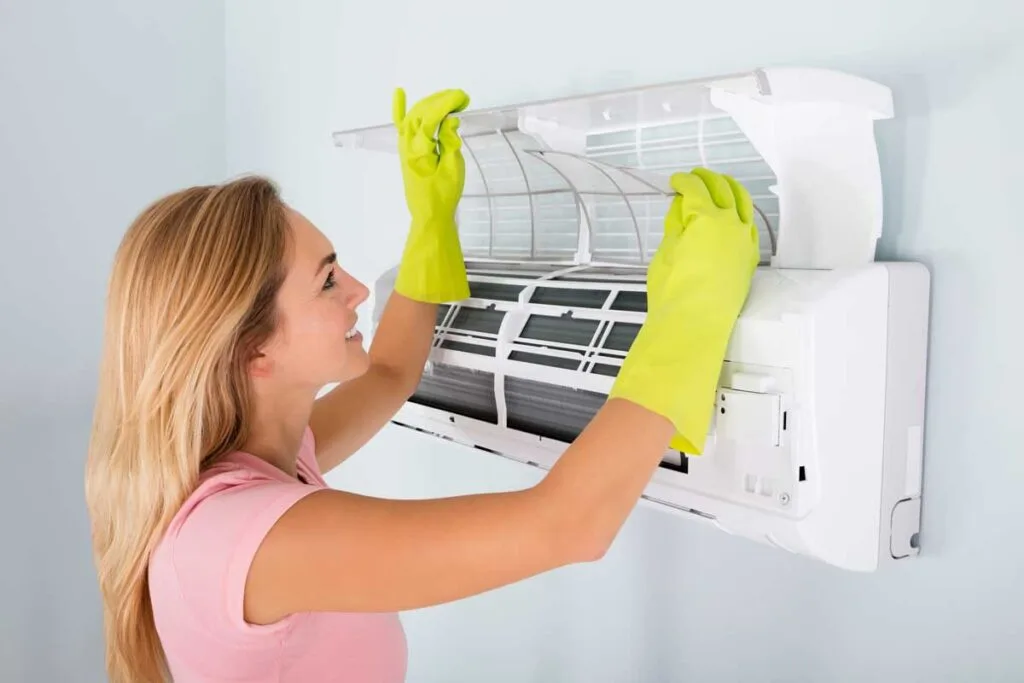 A woman is wokring on an Air Conditioning Maintenance task