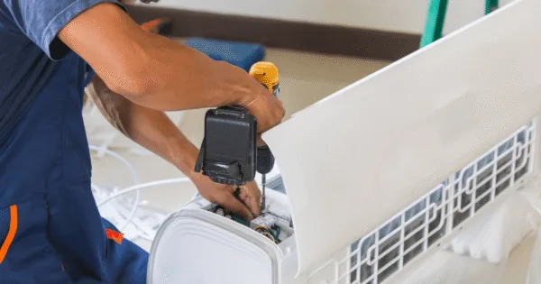 The technician is doing an emergency air conditioning service Gold Coast.