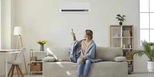 A woman in the room which is spacious suiting for her air conditioning size.