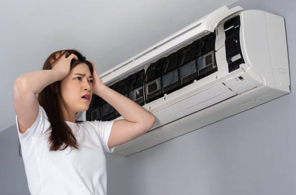The women is struggling with air conditioner power outage.