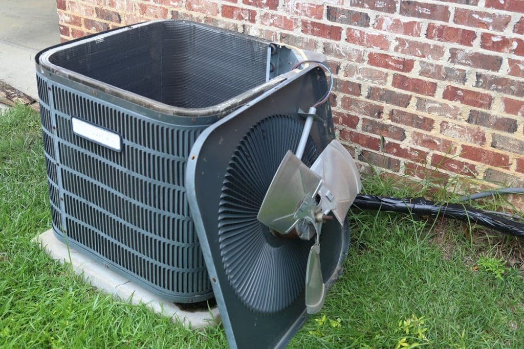Damaged outdoor HVAC unit with broken fan blade, possibly the cause when HVAC stops working suddenly.