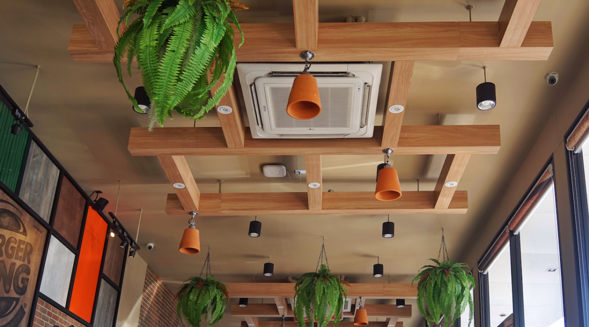 Ceiling-mounted cassette air conditioner in a stylish restaurant, maintaining optimal temperature for a restaurant.