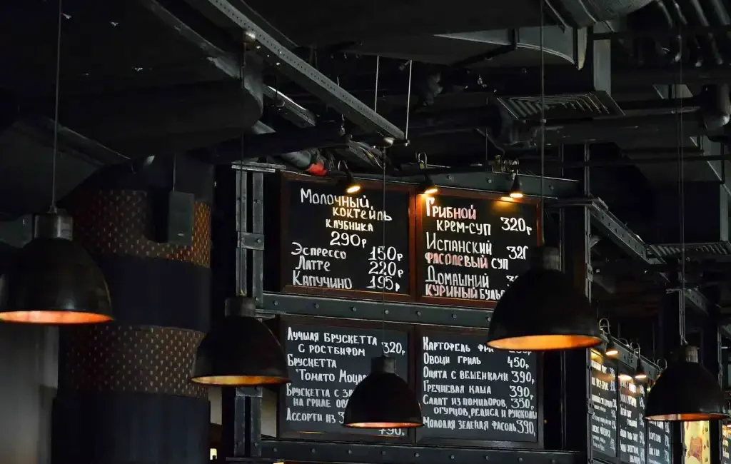 Industrial-style restaurant with exposed ductwork showing signs it’s time to upgrade your restaurant HVAC system.