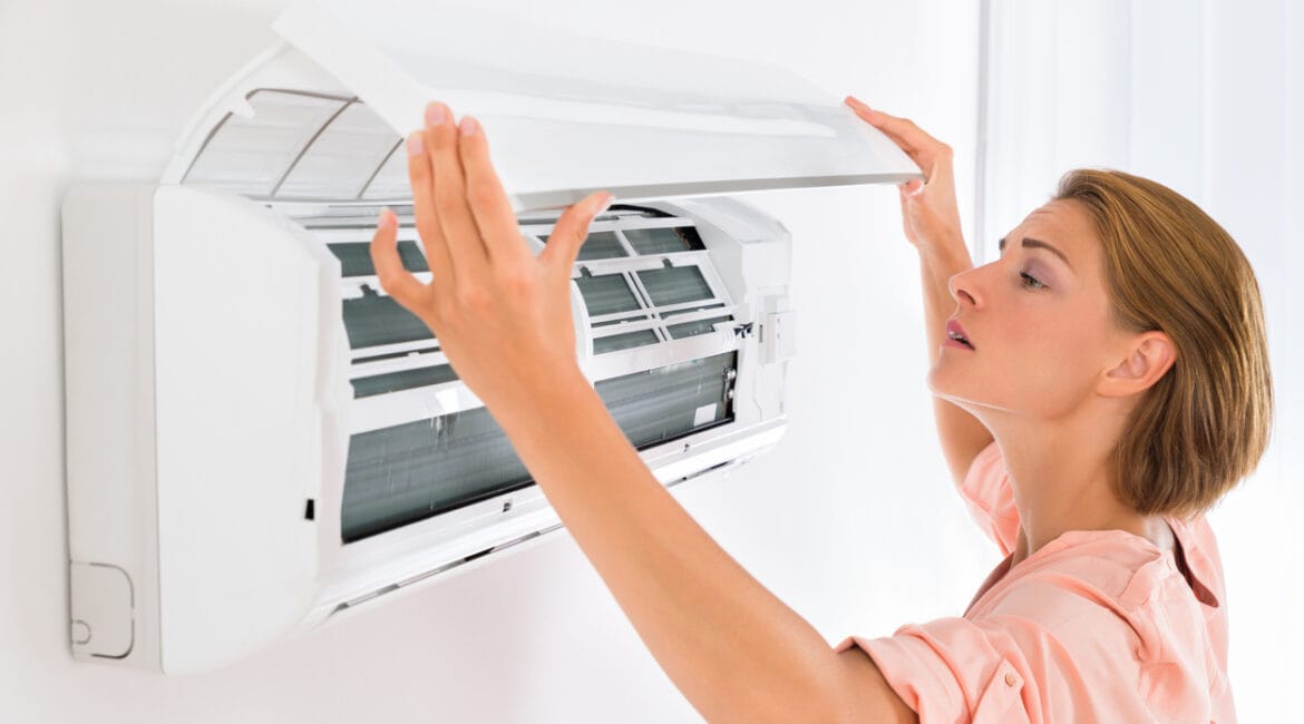 Young woman opens Daikin air conditioners at home