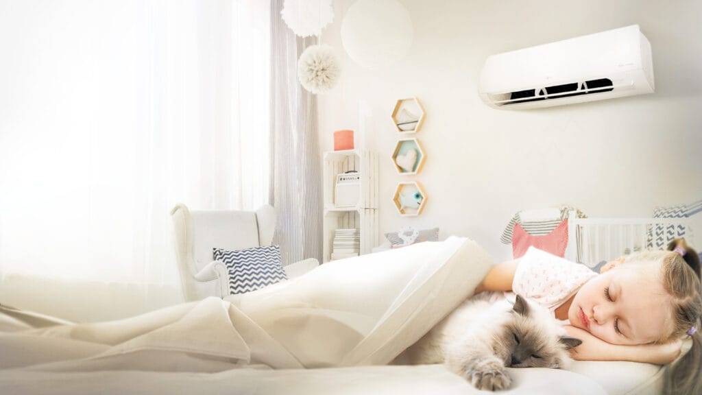 A little girl peacefully napping with a fluffy cat in a bright, cozy room cooled by an LG air conditioner — showcasing why LG is a top choice for air conditioning in Gold Coast homes with children.