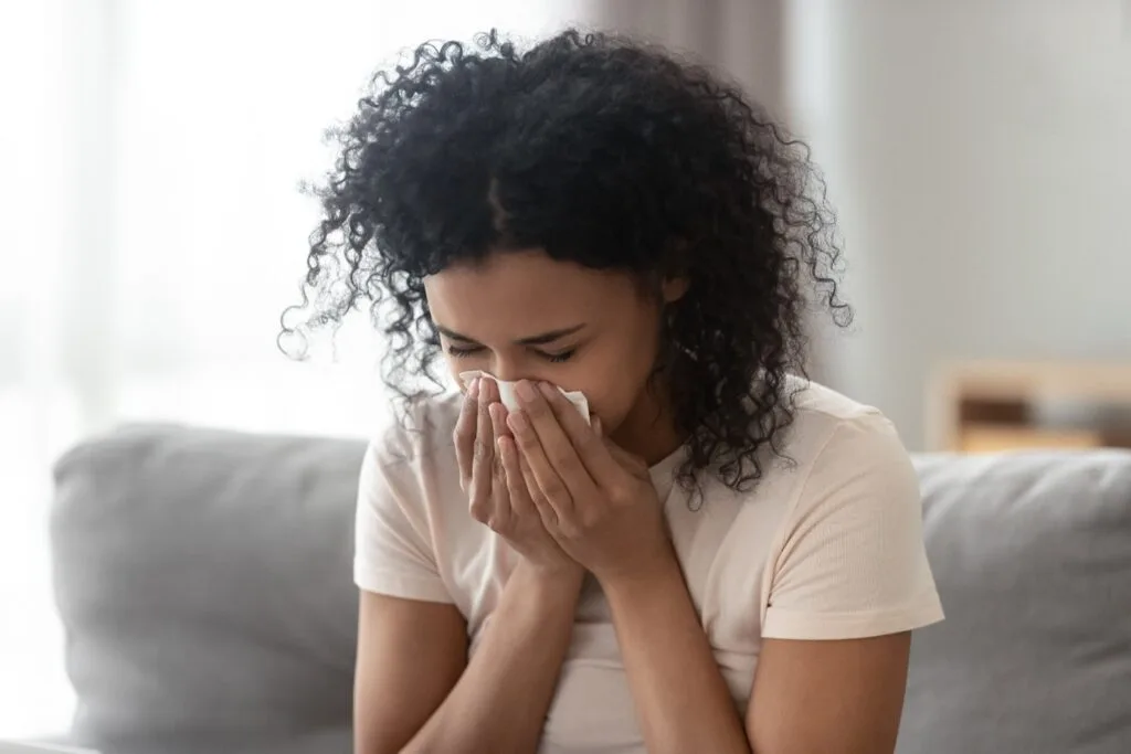 Young woman experiencing air conditioner lung symptoms, air conditioning Gold Coast. 