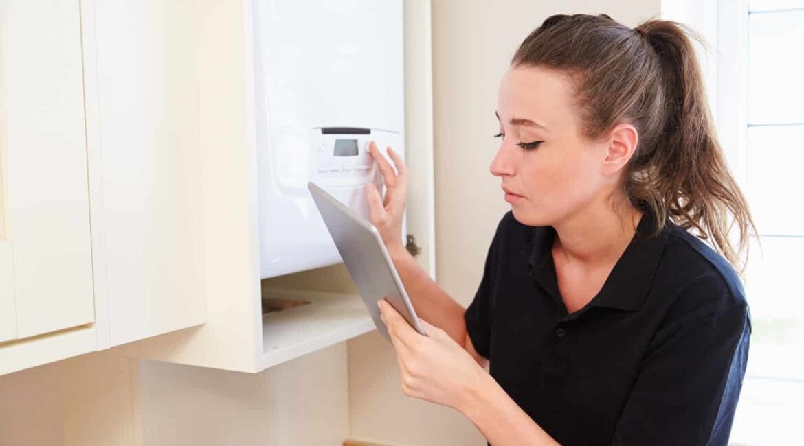 The woman is checking checklist to turn on the heating mode on her AC.
