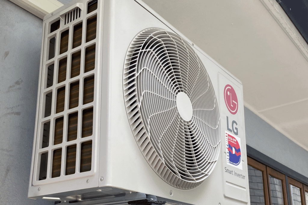 LG Smart Inverter AC outdoor unit installed close to a residential wall. When an AC outdoor unit is making loud noises, it could indicate a faulty motor or mounting vibration. Reach out for air conditioning repair Gold Coast service to prevent further damage - DEEPCHILL