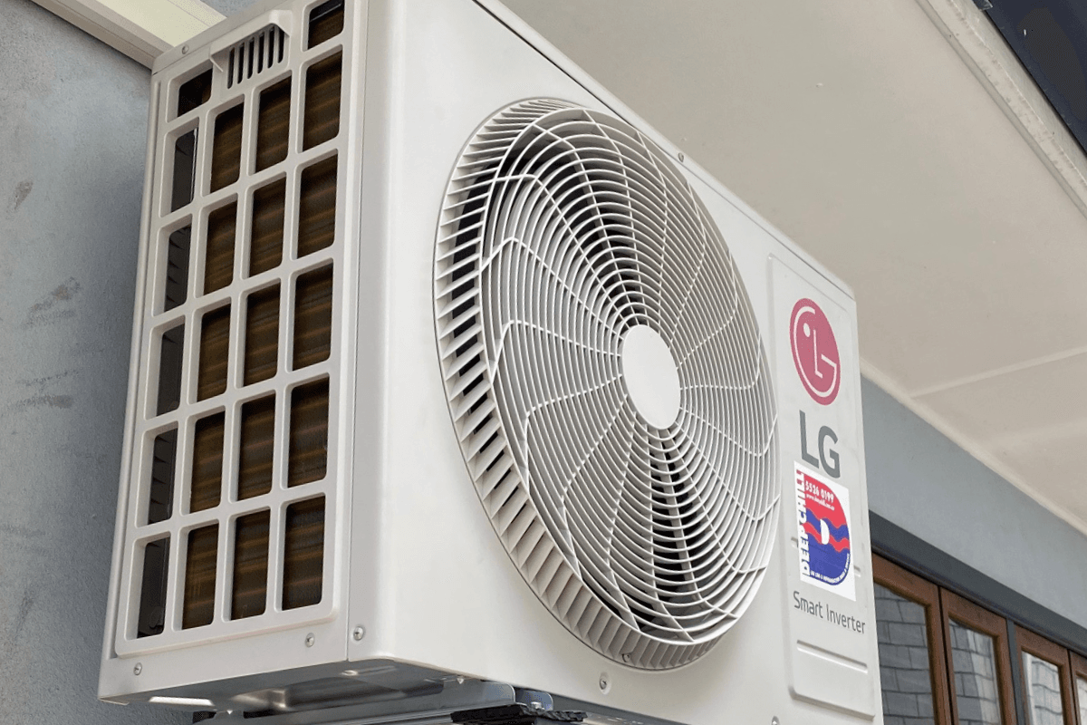 LG Smart Inverter AC outdoor unit installed close to a residential wall. When an AC outdoor unit is making loud noises, it could indicate a faulty motor or mounting vibration. Reach out for air conditioning repair Gold Coast service to prevent further damage - DEEPCHILL