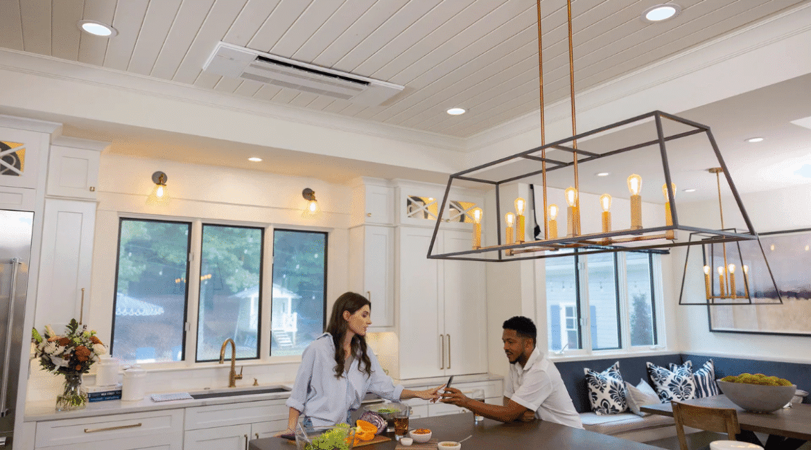 A stylish modern kitchen featuring a cassette air conditioner installed in the ceiling, offering discreet and efficient cooling—ideal for comparing cassette vs floor-standing air conditioners in DEEPCHILL's expert review on air conditioning Gold Coast.