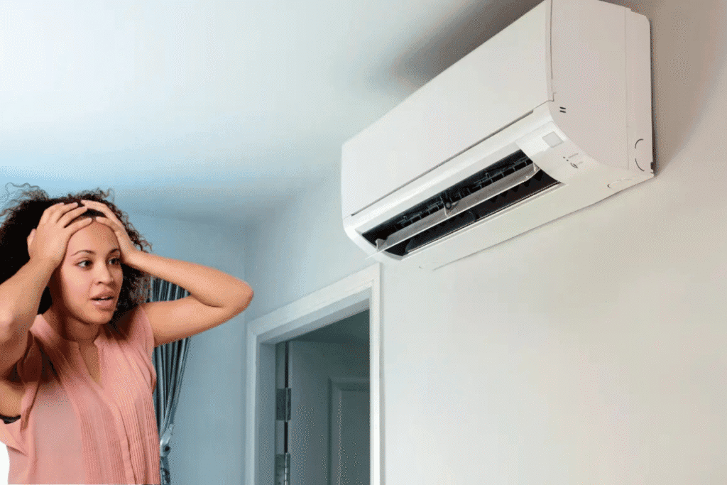 A worried woman looking at her aircon light blinking unexpectedly after turning it on, possibly needing air conditioning repair.