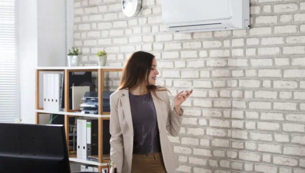 A professional uses a split-system air conditioner to heat her home office effectively and reduce energy costs. 