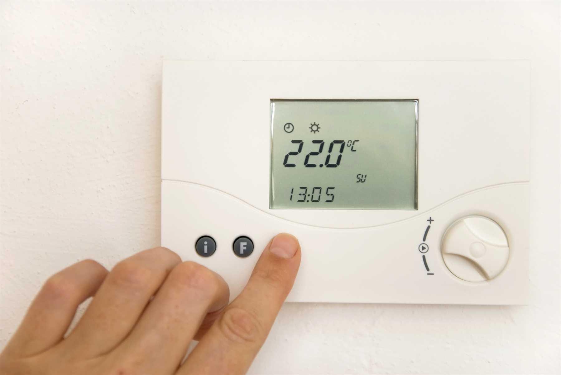 Adjusting the air conditioner temperature for bedroom to 22°C on a wall thermostat.