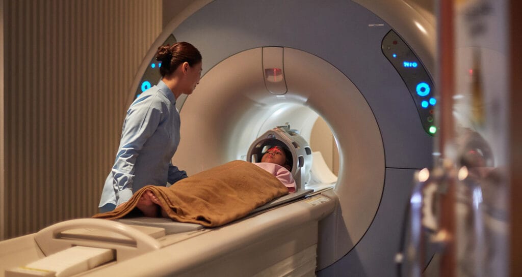 Child receiving MRI scan with a blanket for warmth – highlighting the importance of maintaining the right temperature for hospitals during winter.