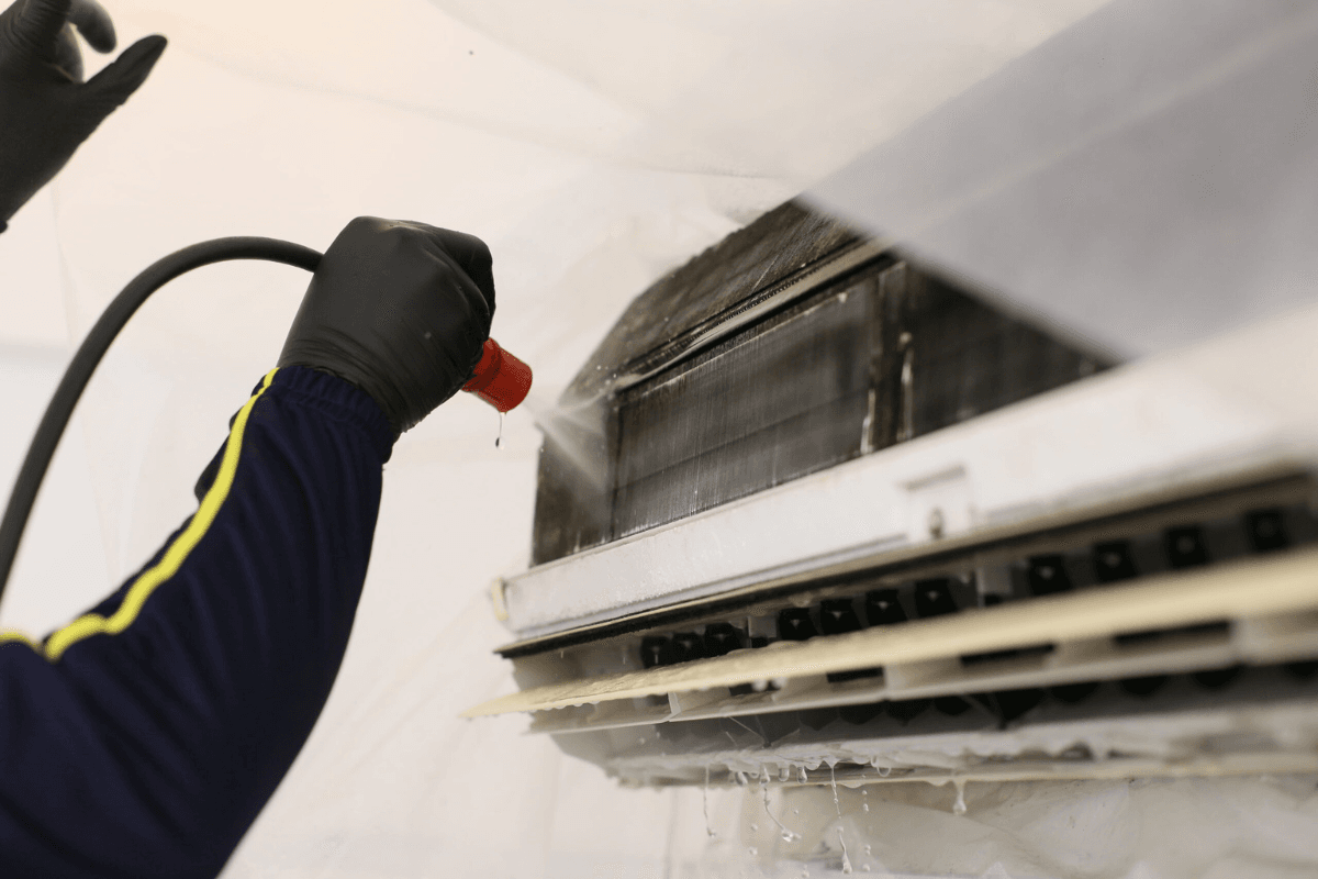 Hydro Clean vs standard servicing - The technician is cleaning customer's air conditioner