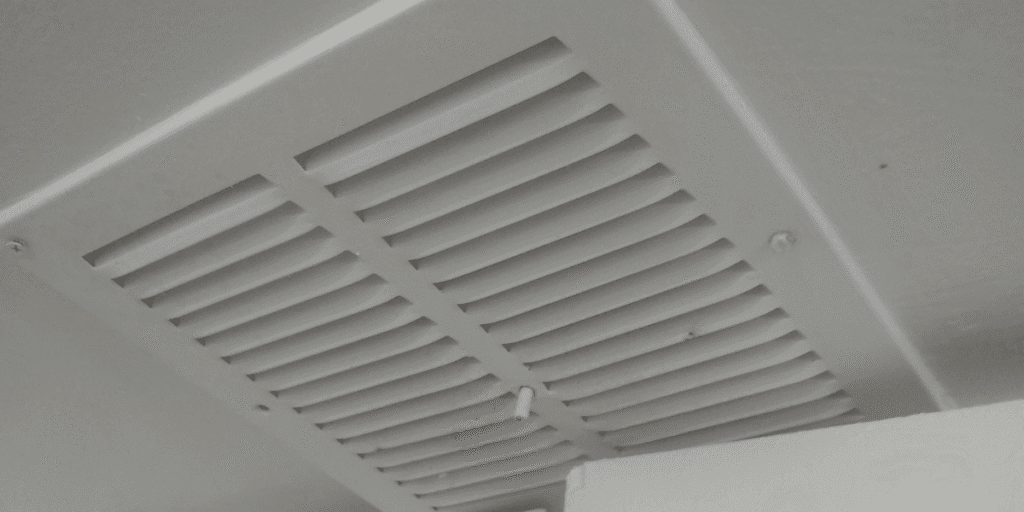 Close-up of air vent showing risk of roaches crawling out of your air vents, highlighting the need for vermin treatment and preventative maintenance.