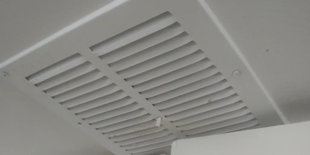 Close-up of air vent showing risk of roaches crawling out of your air vents, highlighting the need for vermin treatment and preventative maintenance.