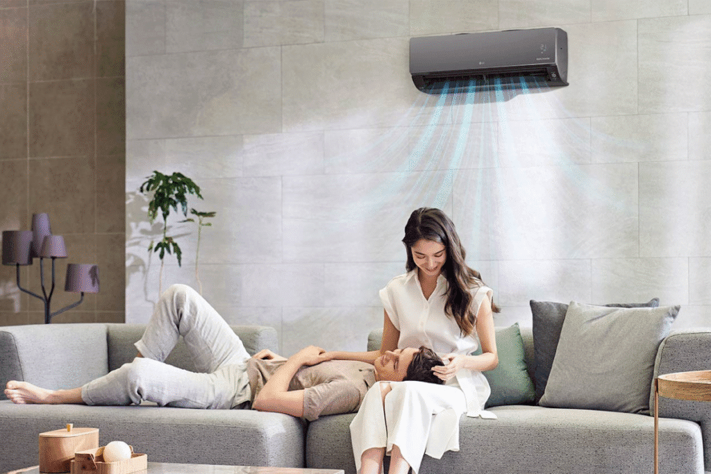 Happy couple enjoying clean, fresh air at home after a professional hydroclean aircon service, ensuring healthy indoor air quality.