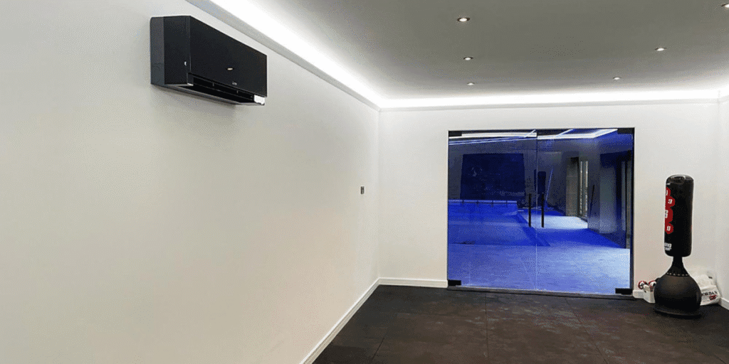 Private workout studio equipped with a wall-mounted AC unit, showing how air conditioning in gyms improves performance with air conditioning Gold Coast solutions.