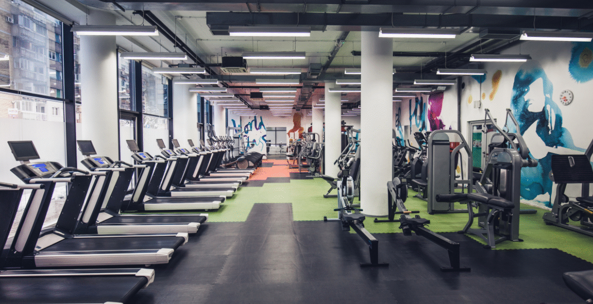 Modern fitness centre with treadmills and strength machines, highlighting the importance of air conditioning maintenance for gyms, including Hydro Clean services by air conditioning Gold Coast specialists.