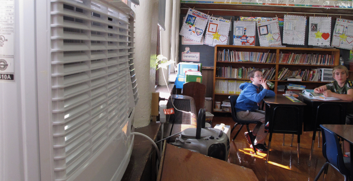 Classroom with students and window AC unit, demonstrating air conditioning regulations in schools and how air conditioning Gold Coast supports safe learning.