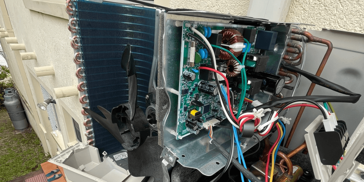 Exposed air conditioner PCB and fan during inspection – book preventative maintenance now with reliable air conditioning Gold Coast services to prevent breakdowns.