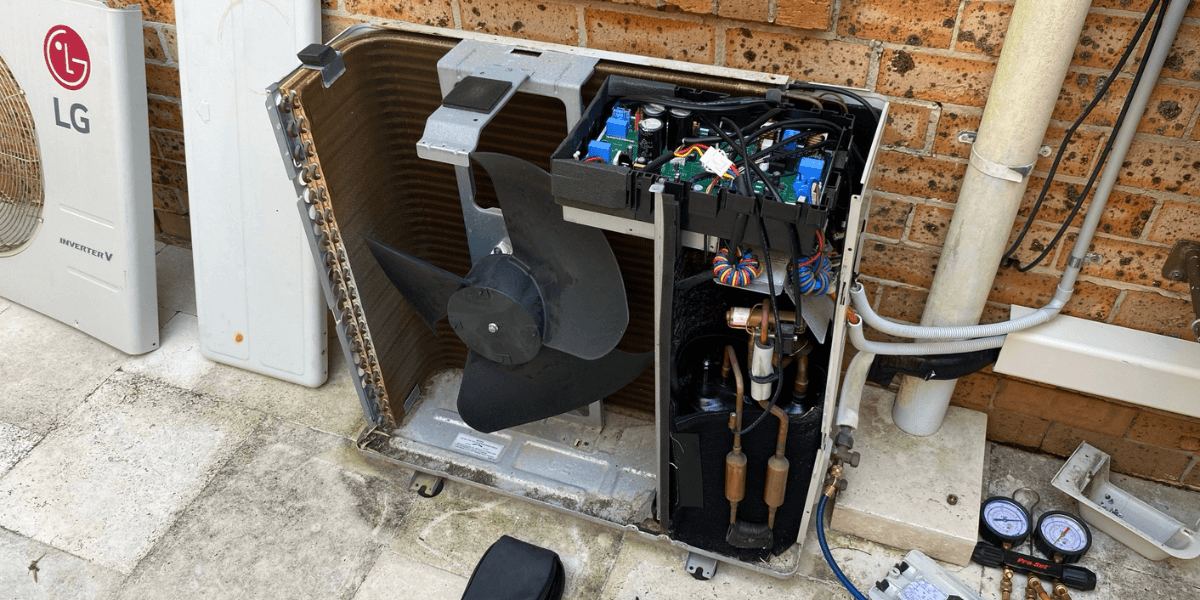 Technician performing AC check to do preventative maintenance on outdoor unit, ensuring reliable air conditioning Gold Coast service.