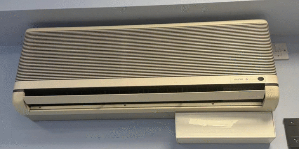 Aging split system air conditioner indoors, where homeowners may wonder if they can recharge old air conditioner or call air conditioning Gold Coast services.