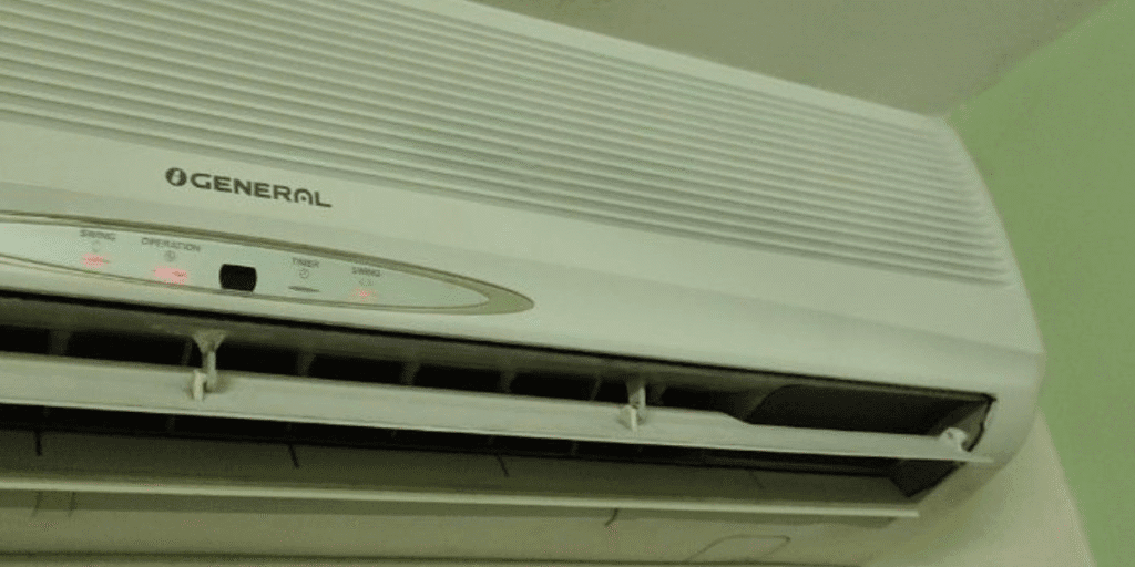 An older O’General split AC showing operation lights, raising questions about whether to recharge old air conditioner or upgrade with air conditioning Gold Coast service.