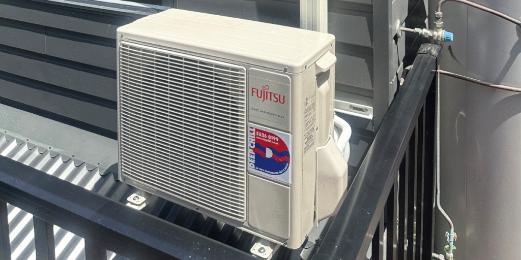 Outdoor unit not running — Fujitsu DC Inverter air conditioner mounted beside water heater, inspected by DEEPCHILL air conditioning Gold Coast team.