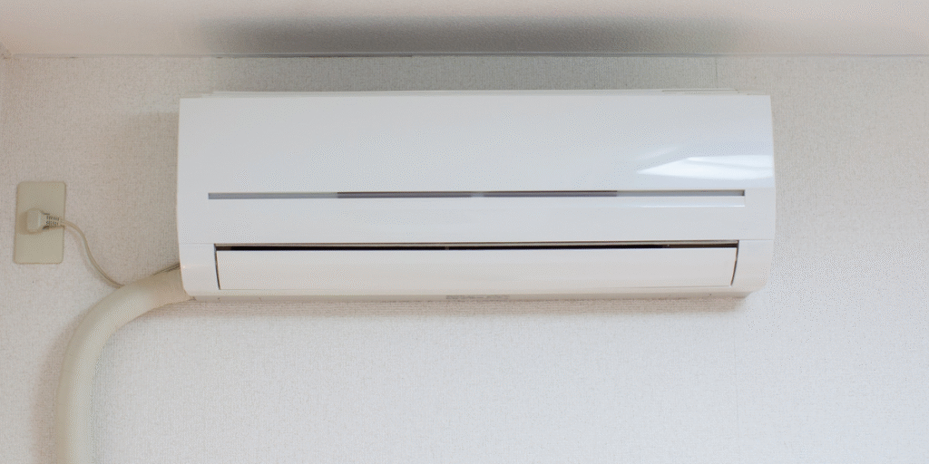 Close-up of a wall-mounted air conditioner unit that is running but not cooling properly, representing common issues faced by homeowners needing air conditioning repair service Gold Coast.
