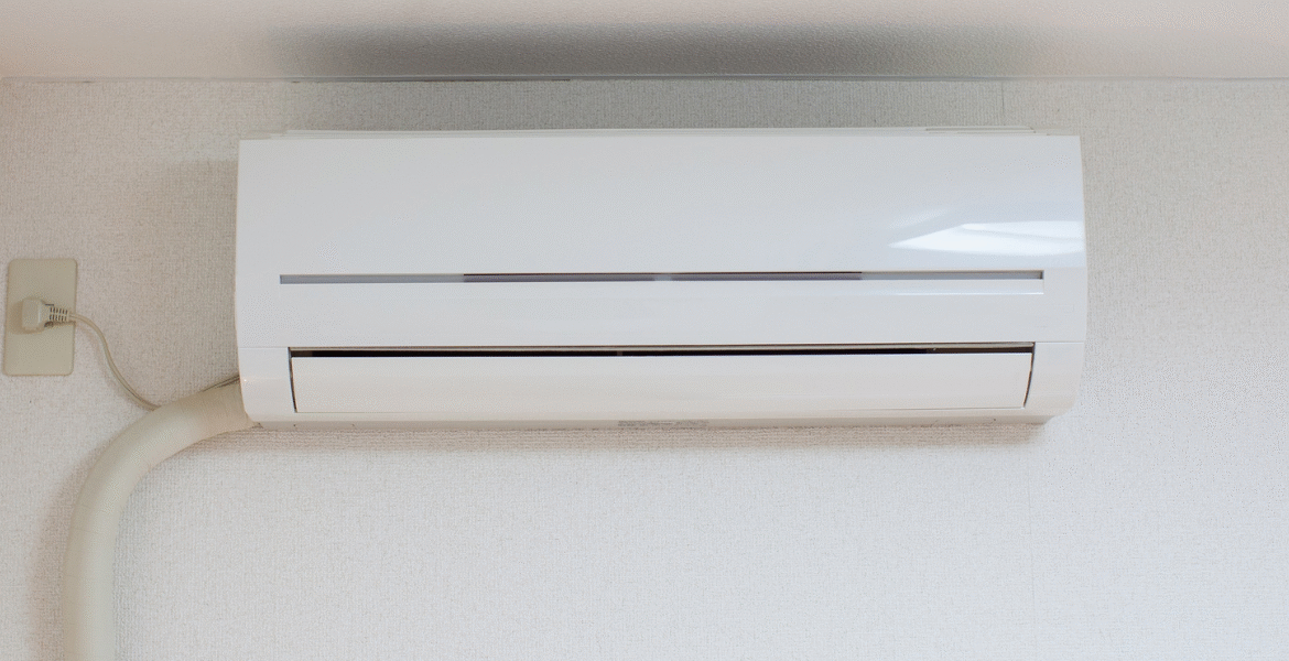 Close-up of a wall-mounted air conditioner unit that is running but not cooling properly, representing common issues faced by homeowners needing air conditioning repair service Gold Coast.