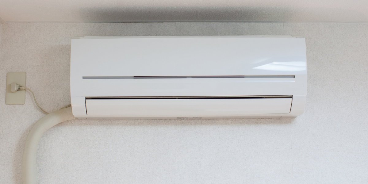 Close-up of a wall-mounted air conditioner unit that is running but not cooling properly, representing common issues faced by homeowners needing air conditioning repair service Gold Coast.
