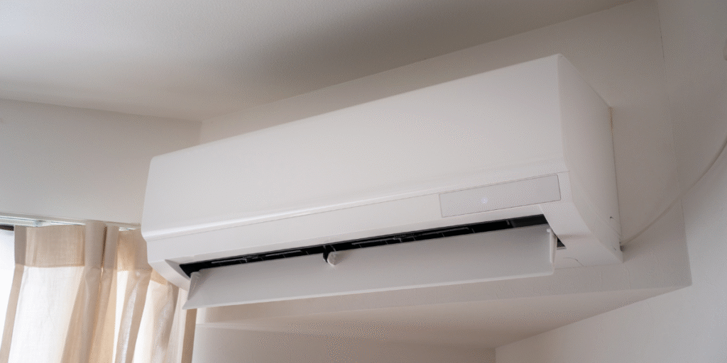 An air conditioner with open vents operating under sunlight, illustrating how poor airflow can cause an air conditioner not cooling during the day in Gold Coast properties.