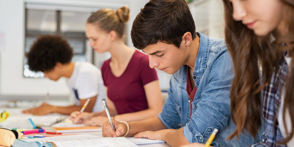 High school students taking exams in a comfortable classroom — cool classrooms close learning gap and improve focus with air conditioning Gold Coast.