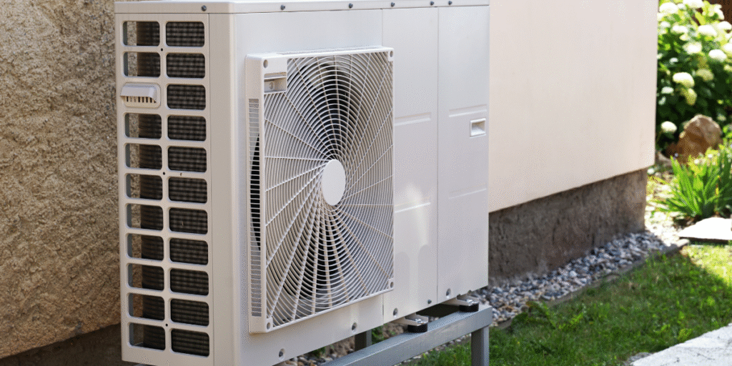 Outdoor air conditioning unit installed beside a house, showing proper ventilation and safe setup — illustrating why you shouldn’t fully cover the outdoor unit in the hot weather, according to air conditioning Gold Coast experts.