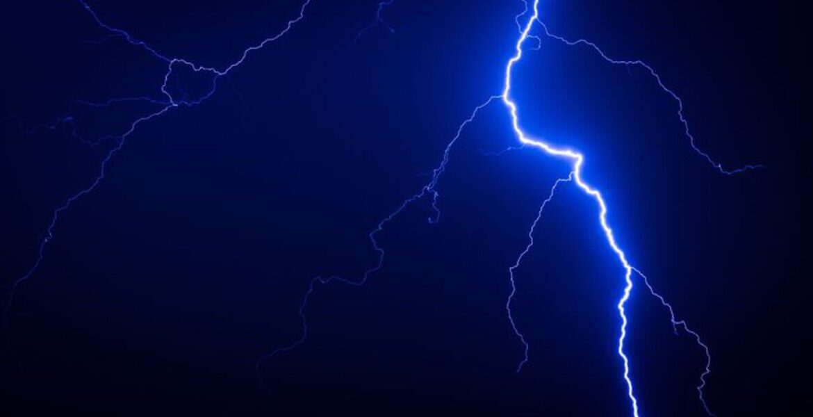 Close-up of lightning bolt during storm — illustrating power surge risks when people use air conditioner during thunderstorms, shared by air conditioning Gold Coast experts.