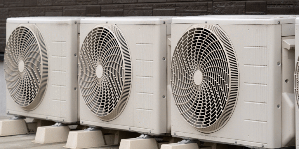 Multiple outdoor air conditioner units installed side by side on a building platform, showing how rain can get into the outdoor air conditioner unit while maintaining airflow – air conditioning Gold Coast.