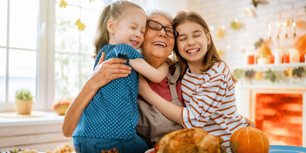 A grandmother hugging her grandchildren in a warm Thanksgiving atmosphere, feeling thankful for reliable air conditioning maintenance Gold Coast.