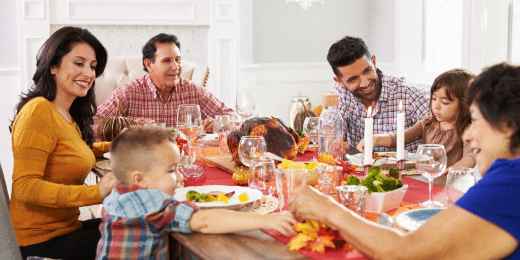 A happy Gold Coast family enjoying Thanksgiving dinner together in a cool and comfortable home after completing air conditioning maintenance Gold Coast.