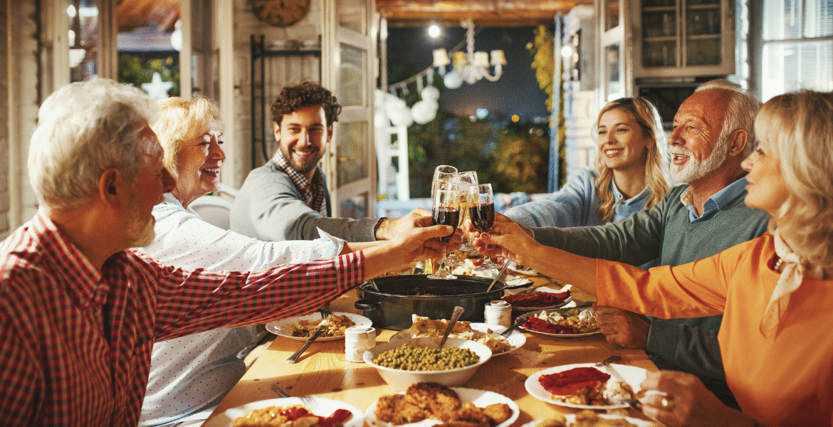 Family and friends toasting at a festive Thanksgiving dinner, celebrating comfort and relaxation with well-maintained air conditioning Gold Coast.