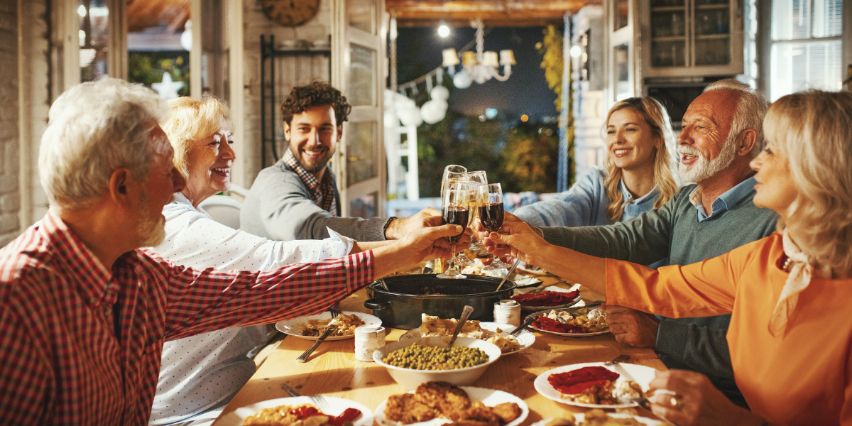 Family and friends toasting at a festive Thanksgiving dinner, celebrating comfort and relaxation with well-maintained air conditioning Gold Coast.