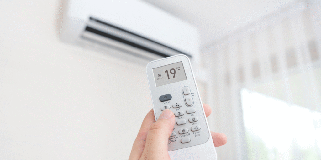 Adjusting temperature to 19°C on a remote control, showing the effects of keeping air conditioner below 20°C for better comfort and air conditioning Gold Coast efficiency.