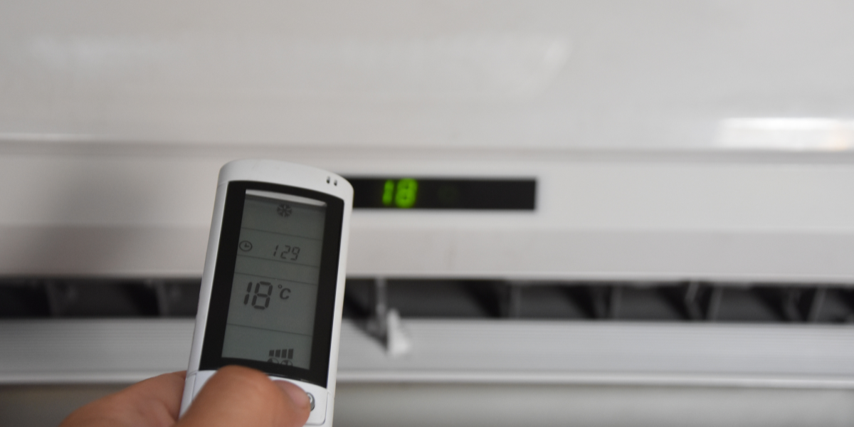 Close-up of an air conditioner remote set to 18°C, showing a thermostat change on its own while adjusting an air conditioning Gold Coast unit.