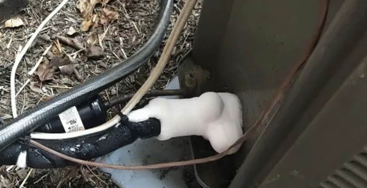 Frozen copper pipe at the AC outdoor unit with heavy ice formation, a sign of low refrigerant or airflow problems in air conditioning Gold Coast.